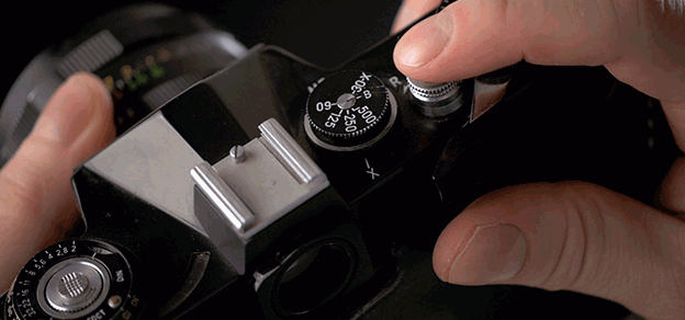An individual skillfully using a Kodak camera to create timeless photographs. Embrace the artistry of photography with Kodak.