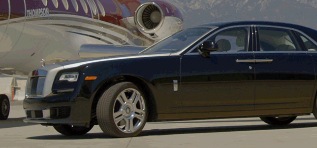 Rolls-Royce luxury car parked beside a sleek airplane, embodying elegance and refinement in both land and air travel. 