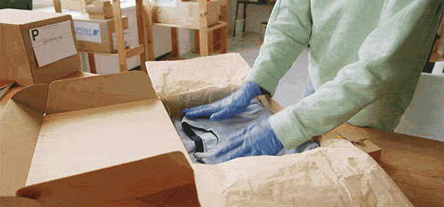someone packing a box at JD headquarters 