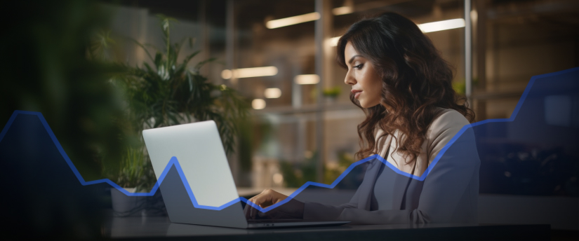 A focused woman analyzing market trends on her laptop, with a graph chart displayed on the screen, amidst the stress of trading.