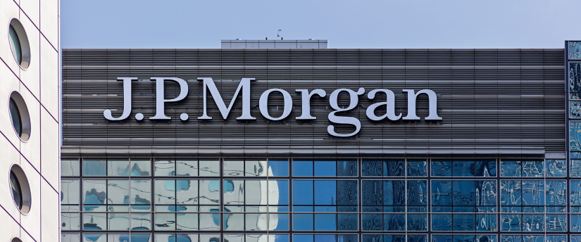 JPMorgan sign on a tall building with glass windows and a modern architectural design.