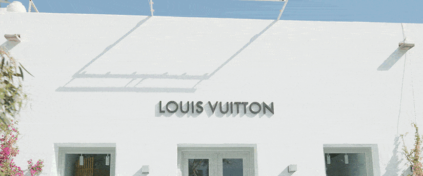 Elegant Louis Vuitton logo gracing a building facade, a symbol of timeless luxury and impeccable craftsmanship. Discover opulence in every detail.
