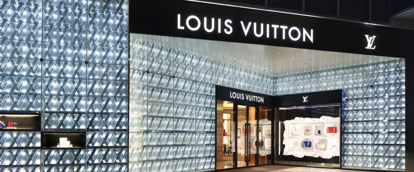Louis Vuitton logo on a luxury store with intense lights