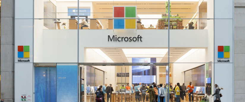 A modern retail space showcasing the iconic Microsoft logo and offering a wide range of products and services.
