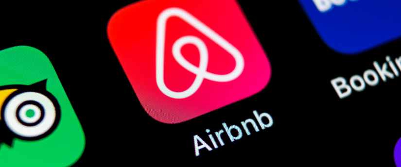 A screenshot of the Airbnb app homepage showing search bar, popular destinations, and user profile icon