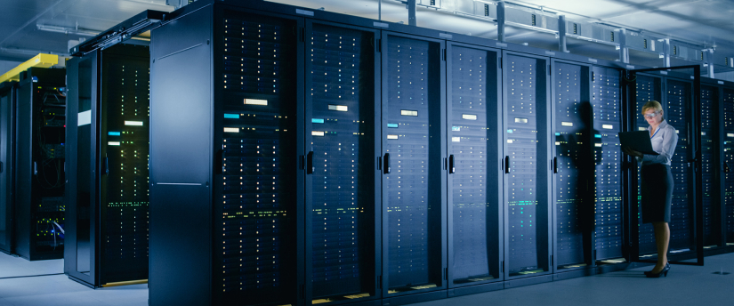 A woman standing in front of a large server room filled with Equinix servers.