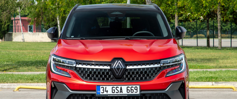 A red Renault car parked on the street, showing its front end