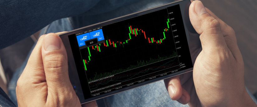 A person holding a smartphone displaying a stock market graph, indicating cfd or share trading.