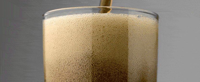 A glass of Coca Cola, filled with refreshing liquid, ready to be enjoyed.