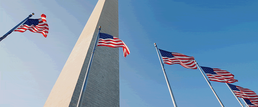 A grand monument with flags fluttering in front of it