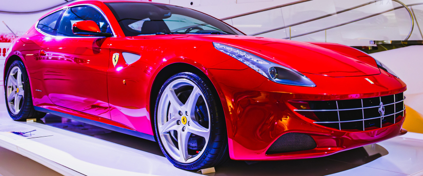 Red Ferrari luxury electric vehicle on display in showroom