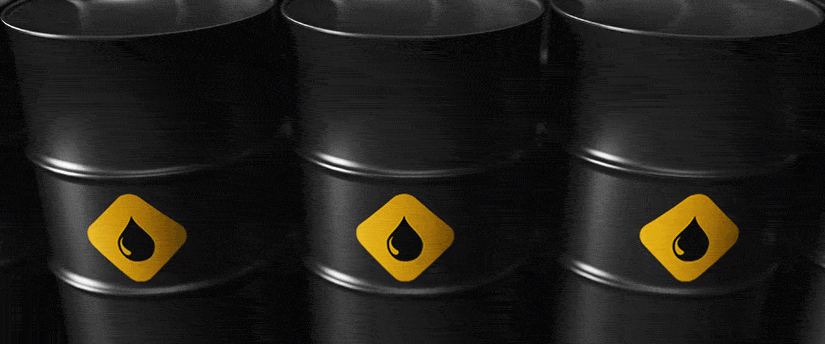 A group of black oil barrels with yellow symbols on them.