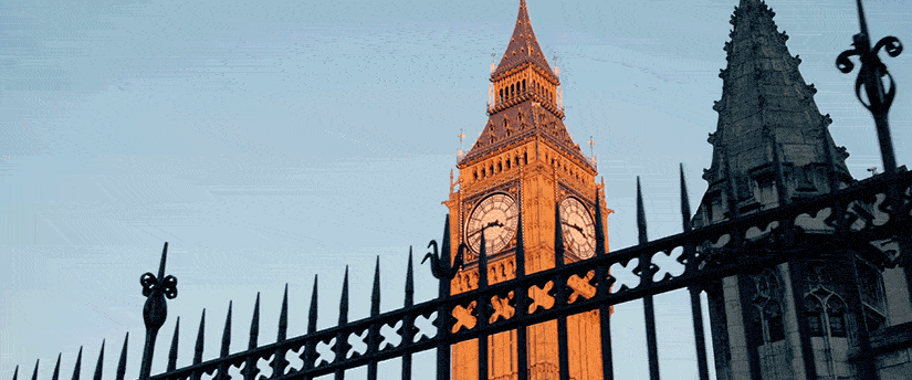 A tall clock tower with a clock on it, symbolizing UK elections, reminiscent of Big Ben.