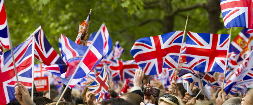 Large group of individuals holding British flags during UK elections.