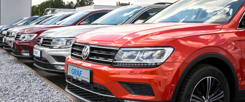 Row of red and silver Volkswagen SUVs parked in lot