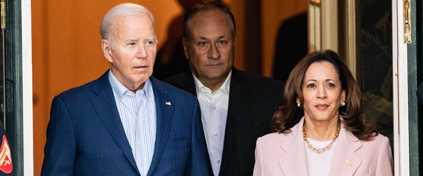Image of President Biden and Vice President Kamala Harris standing together at a podium during a press conference.