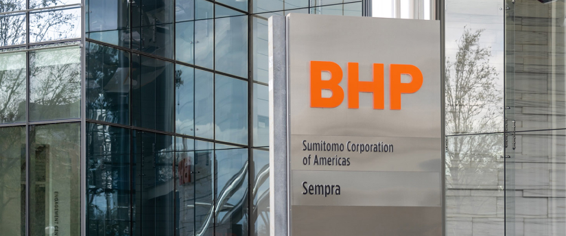 A large sign prominently displaying the BHP logo, symbolizing the company's global presence and influence in the mining and resources sector.