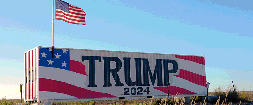 Roadside sign reading "Trump" in bold letters, indicating support for the political figure.