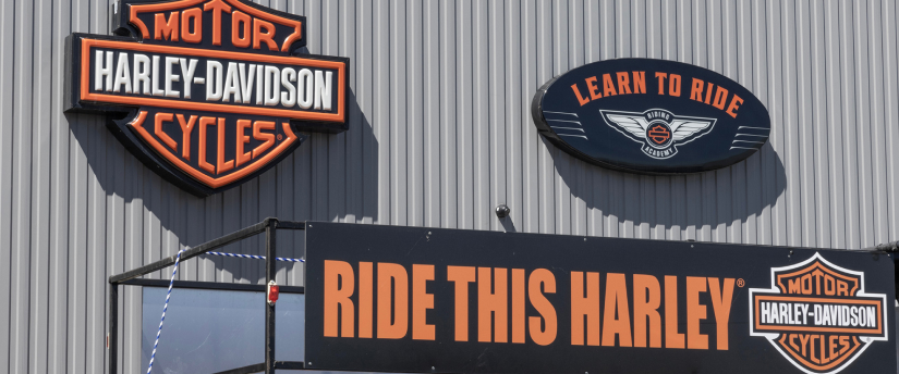 A vibrant Harley-Davidson motorcycle dealership showcasing a variety of bikes and merchandise in a welcoming environment.