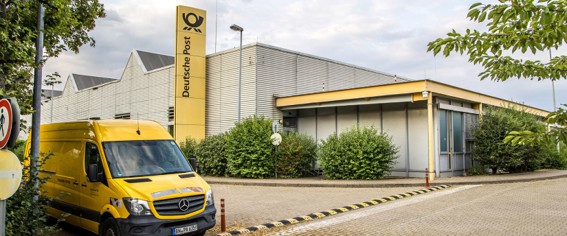 A bright yellow van is stationed in front of a building, adding a pop of color to the surrounding environment.