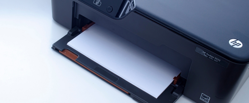 A printer featuring a paper tray positioned on top, showcasing its compact design and functionality.
