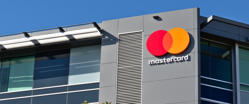 Mastercard logo displayed prominently on the exterior of a building, showcasing brand visibility in an urban setting.