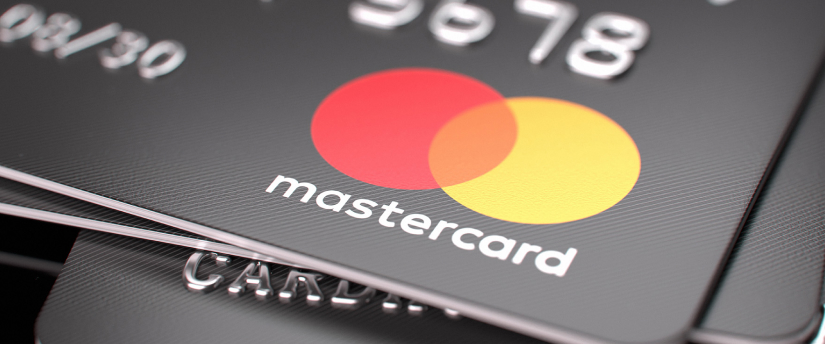 Multiple Mastercard credit cards arranged together, highlighting their distinct designs and branding.