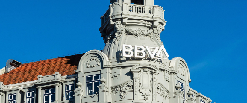 The BBVA building in Madrid, Spain, showcasing modern architecture against a clear blue sky.