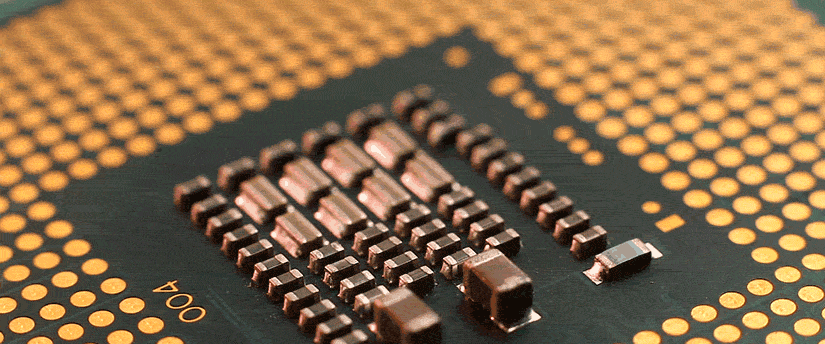 A close-up view of a CPU featuring a small piece of metal attached, highlighting intricate details of the component.
