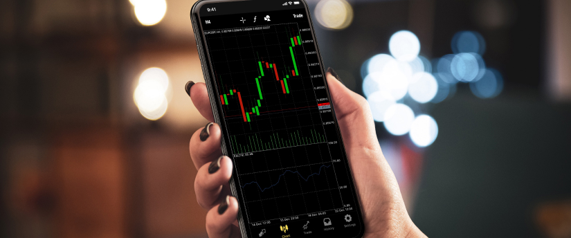 Close-up of an iPhone displaying a forex trading app, highlighting currency exchange rates and market trends.