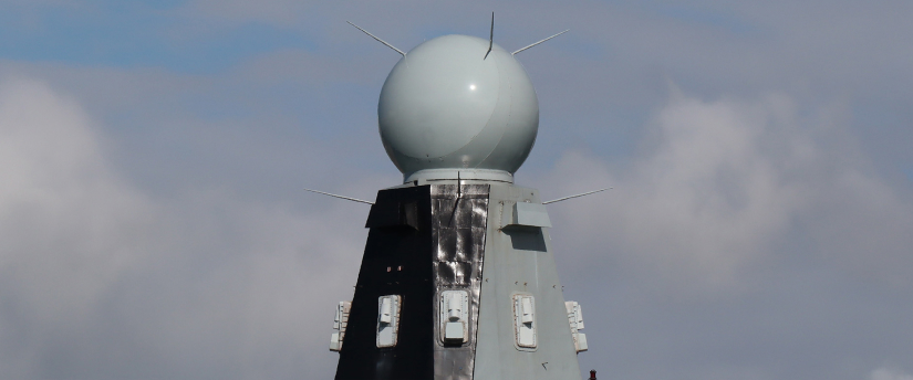 A prominent white sphere is positioned on a building, representing BAE Systems' analytical and connectivity functions.
