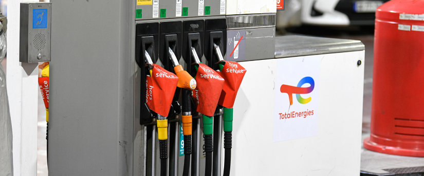 A gas pump with several colored fuel lines, showcasing different fuel options available at a Total Energies station.