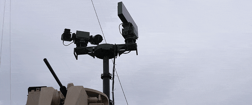 A large antenna atop a building, symbolizing advanced aerospace security systems and communication technology.