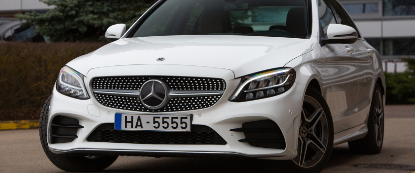 A Mercedes AMG C43 Coupe parked elegantly on a city street, showcasing its sleek design and sporty features.