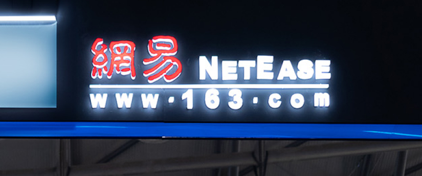 A sign featuring the name "NetEase," linked to the Chinese gaming industry and its stock market activities.