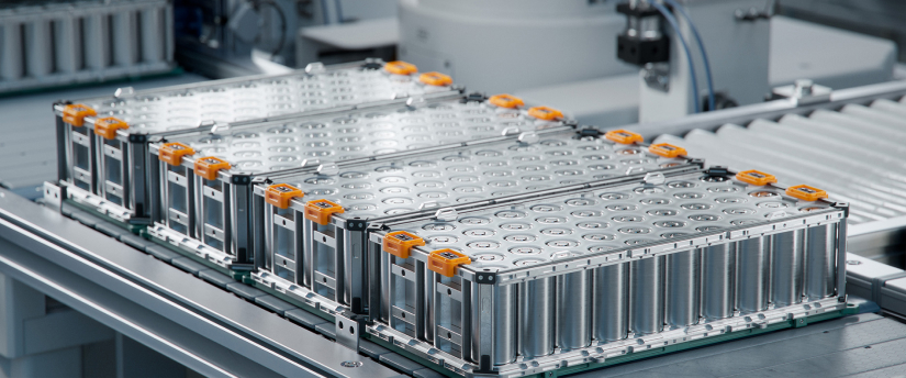 A battery pack is being assembled on a conveyor belt, showcasing the manufacturing process in action.