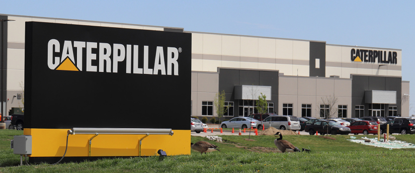 Caterpillar logo on a building representing the company's presence in the construction industry and stock market performance.