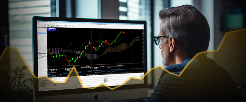 A bespectacled man intently examines a stock chart on his computer screen, analyzing financial data and trading CFD