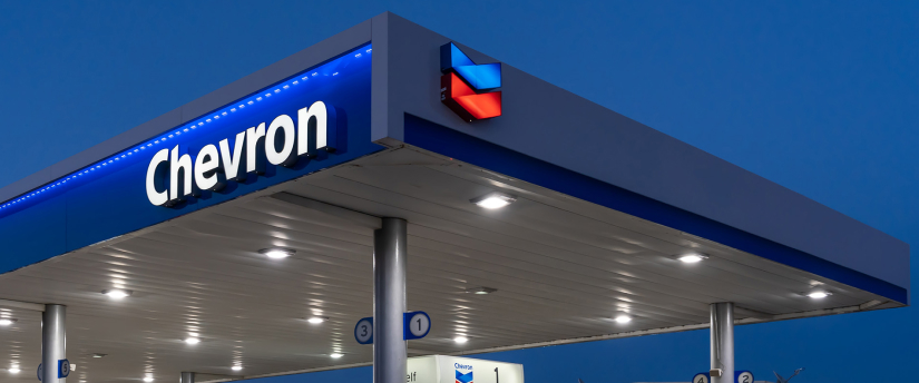 A gas station featuring a prominent Chevron sign, showcasing fuel pumps and a clean, well-maintained exterior.