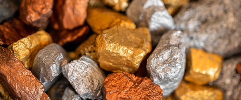 A mixed pile of gold, silver, and copper, highlighting the contrast between the shiny metals in a single collection. Trading commodities market