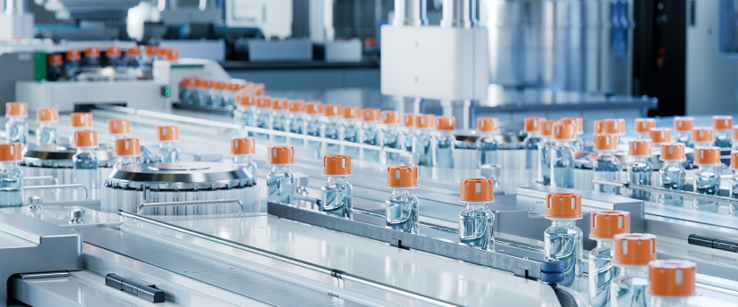 A conveyor belt in a factory displaying a line of bottles moving along the production line.