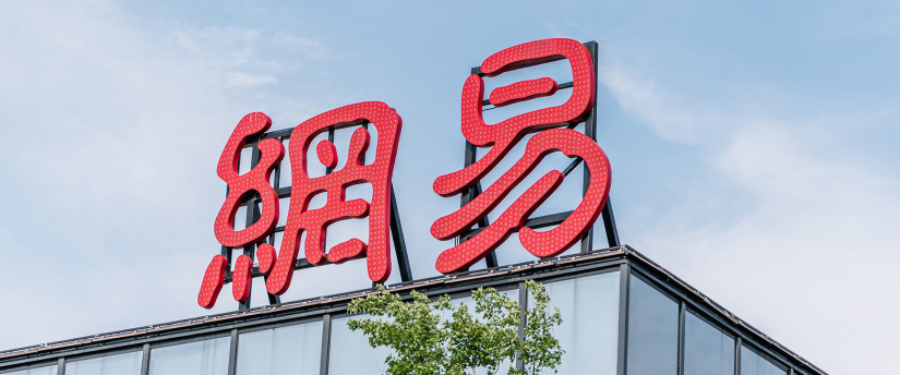 A red sign with Chinese writing displayed on the roof of a building, suggesting a cultural or commercial significance.