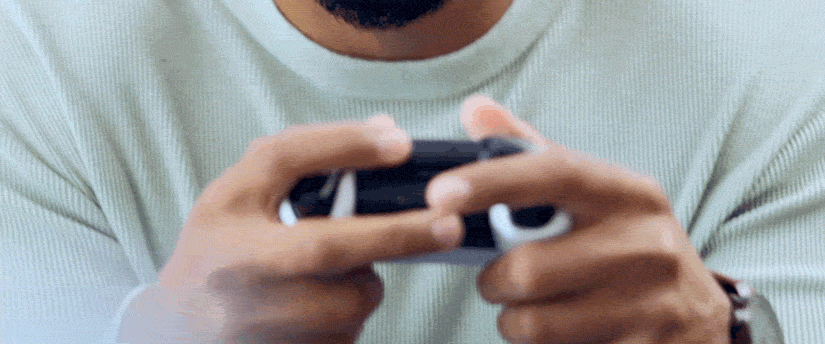 A man gripping a video game controller, engaged in gameplay, showcasing concentration and enthusiasm.