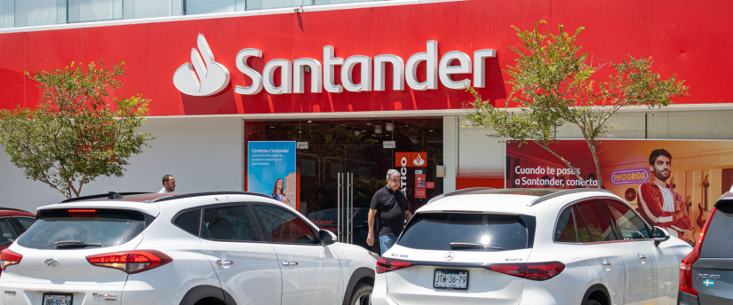 Exterior view of a Banco Santander branch with its red and white logo displayed on the building.