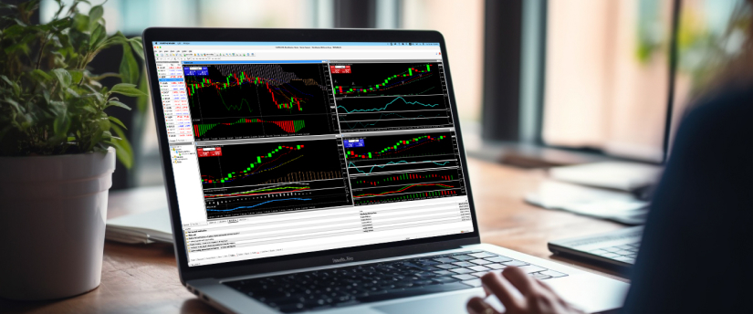 Individual analyzing trading data on a laptop, with graphs and statistics visible on the screen.
