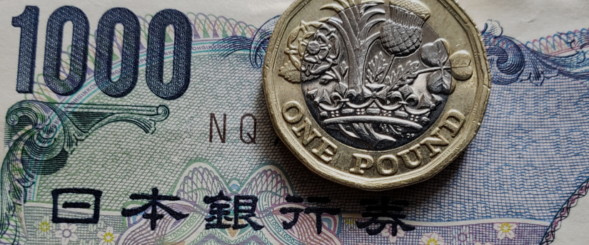 Japanese yen banknotes and coins displayed on a flat surface, showcasing the currency's design and denominations.