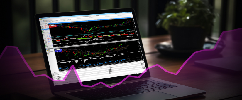 Close-up of a laptop screen displaying forex trading charts, with a hand poised over the keyboard.