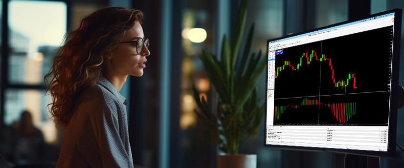 A woman intently observes a computer screen displaying a trading chart, analyzing market trends and data.