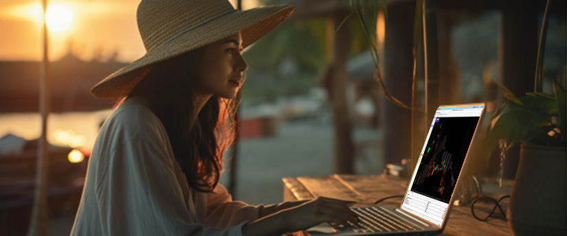 A woman in a hat is engaged in work on her laptop, concentrating on the screen.