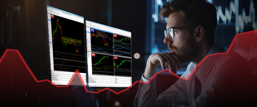 A man wearing glasses analyzes a forex chart displayed on a screen, focusing intently on the data.